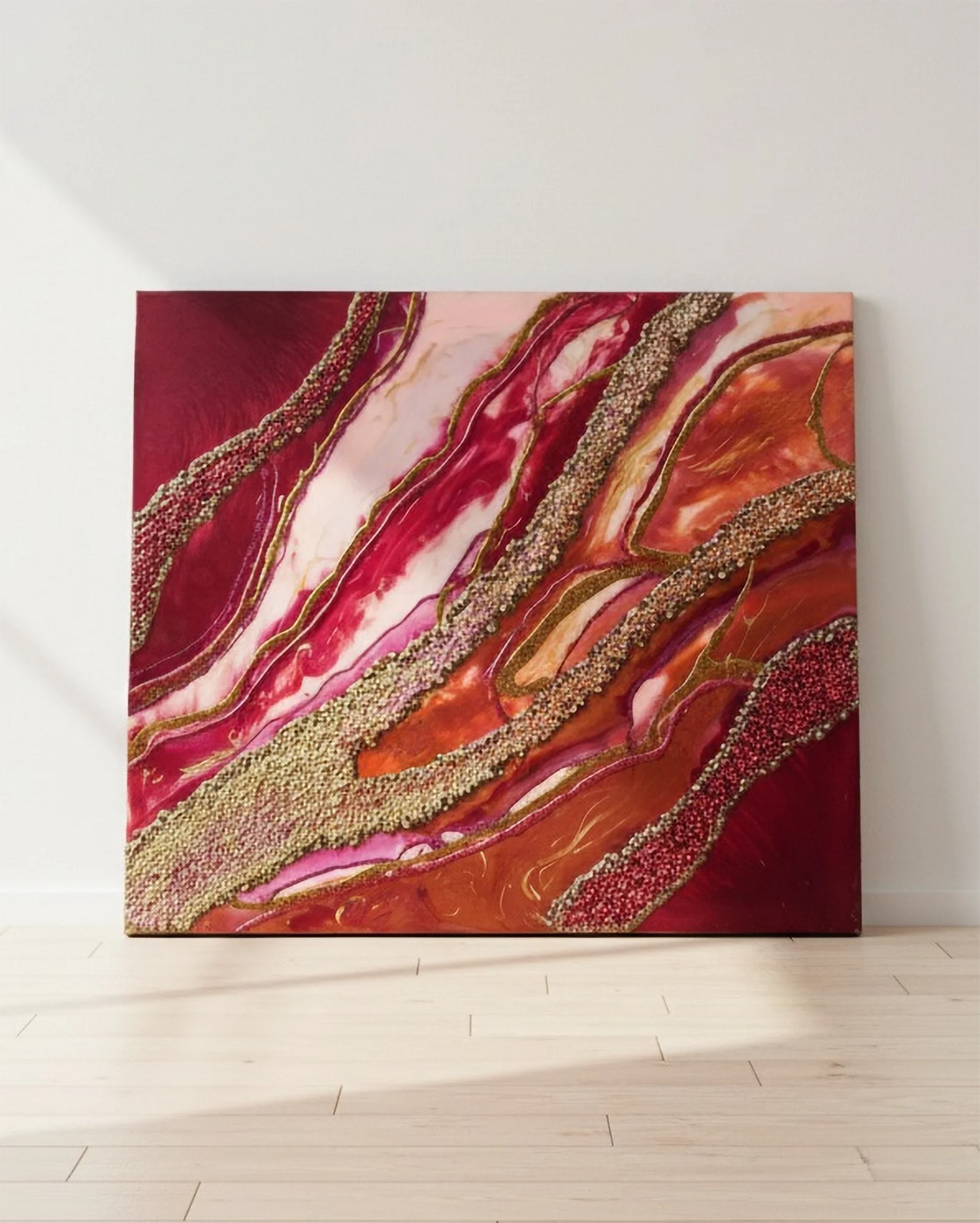 Abstract resin wall art with vivid red, pink, and gold leaf veins on floor against white wall - epoxy resin wall decor